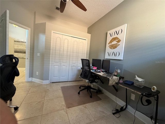 tiled home office featuring ceiling fan, baseboards, visible vents, and a textured ceiling