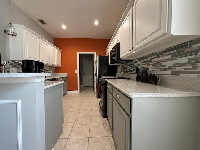 kitchen with light tile patterned flooring, gray cabinets, light countertops, and black range with electric cooktop