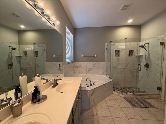 full bathroom with visible vents, a shower stall, a garden tub, and a sink