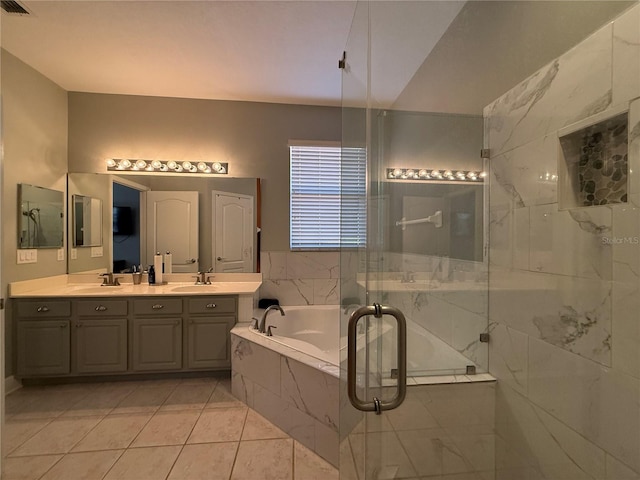 full bathroom featuring a garden tub, double vanity, a marble finish shower, and a sink