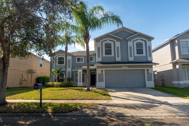 traditional home with a front yard, an attached garage, driveway, and stucco siding