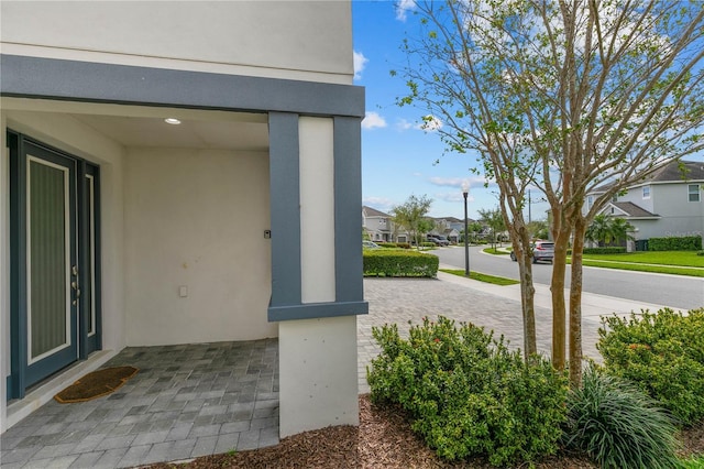 exterior space with stucco siding and a residential view