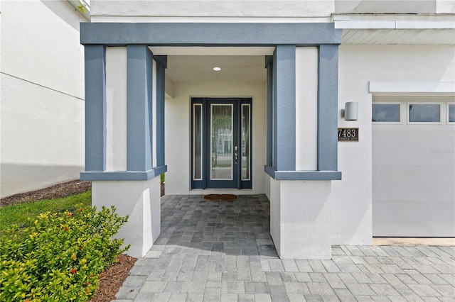 entrance to property featuring stucco siding