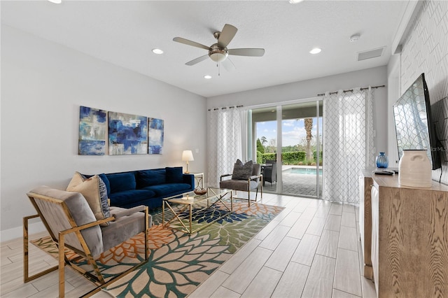 living room featuring wood finish floors, recessed lighting, baseboards, and ceiling fan