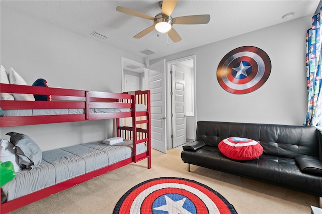 carpeted bedroom featuring visible vents and a ceiling fan