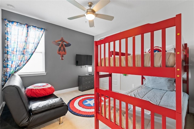 carpeted bedroom with baseboards and ceiling fan