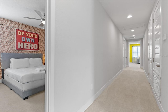 corridor featuring light carpet, recessed lighting, attic access, and baseboards