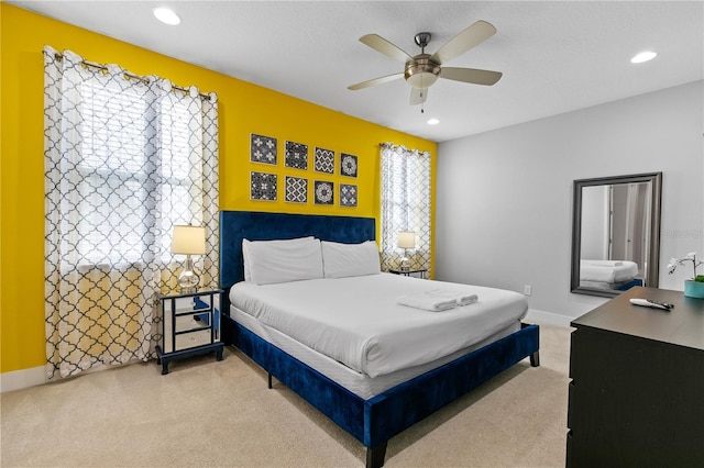 bedroom featuring ceiling fan, recessed lighting, baseboards, and light carpet