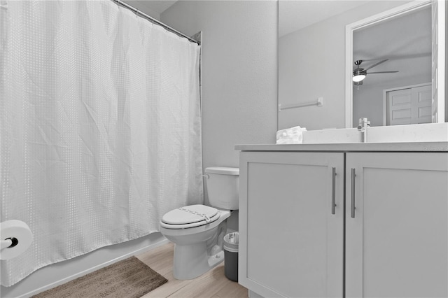 full bathroom with vanity, wood finished floors, shower / bath combo, ceiling fan, and toilet