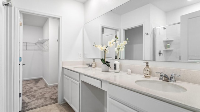 132 Adventure Ave, Davenport, FL 33837 - bathroom with a spacious closet, a stall shower, double vanity, and a sink