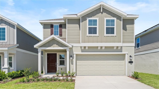 view of front facade with board and batten siding, an attached garage, and driveway