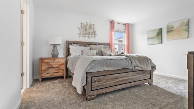 bedroom featuring baseboards and carpet