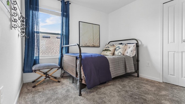 bedroom featuring carpet flooring and baseboards