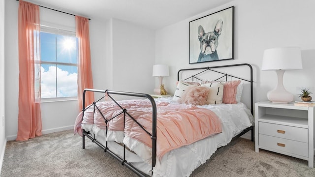 carpeted bedroom featuring baseboards