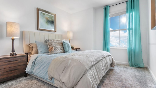 bedroom with baseboards and carpet