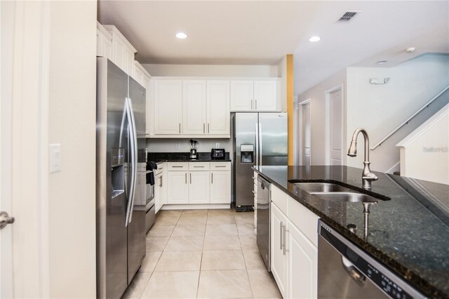7463 Marker Ave, Kissimmee, FL 34747 - kitchen featuring visible vents, a sink, white cabinetry, appliances with stainless steel finishes, and light tile patterned flooring
