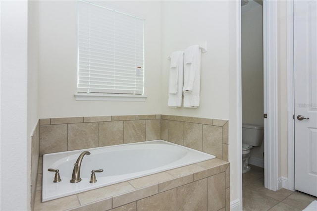 7463 Marker Ave, Kissimmee, FL 34747 - bathroom with toilet, a bath, and tile patterned flooring