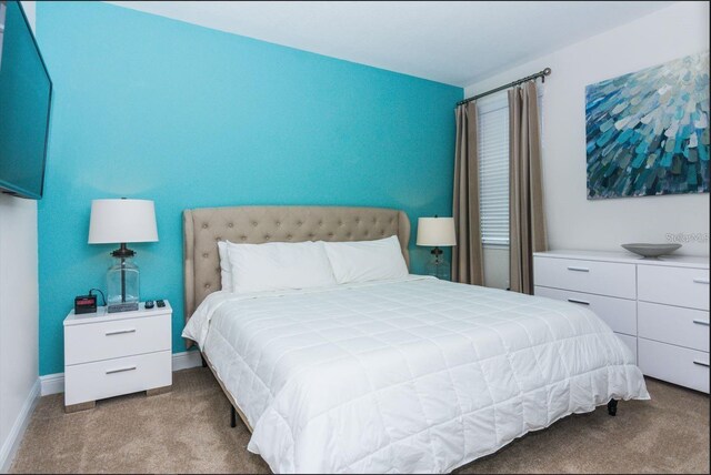 7463 Marker Ave, Kissimmee, FL 34747 - carpeted bedroom featuring baseboards