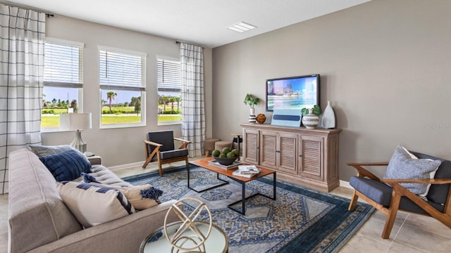 living room featuring visible vents, baseboards, and tile patterned flooring