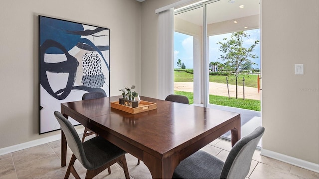 dining room featuring light tile patterned floors and baseboards