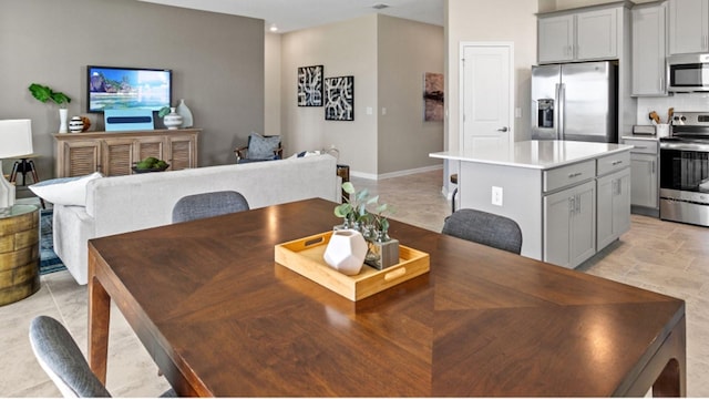 dining space featuring recessed lighting and baseboards