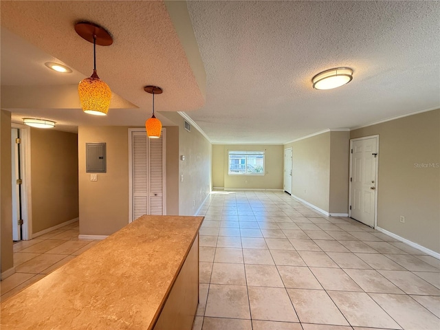 interior space featuring light tile patterned floors, visible vents, electric panel, pendant lighting, and crown molding