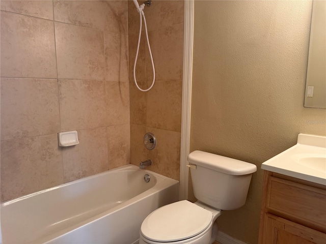 bathroom featuring shower / bath combination, toilet, vanity, and a textured wall