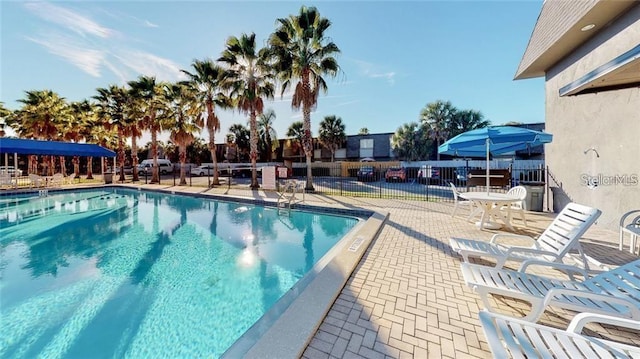 pool featuring a patio and fence