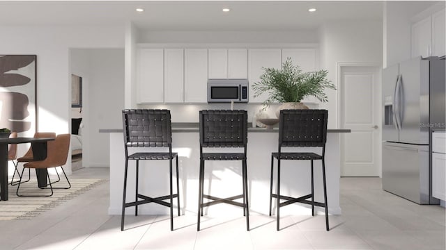 kitchen featuring a breakfast bar, white cabinets, recessed lighting, and appliances with stainless steel finishes