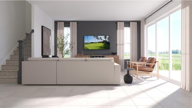 tiled living area featuring a wealth of natural light and stairs