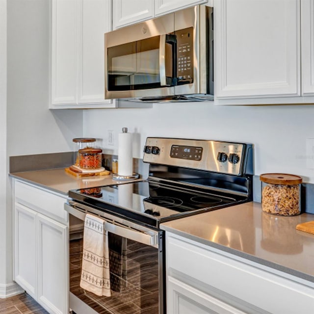 kitchen with stainless steel appliances and white cabinets