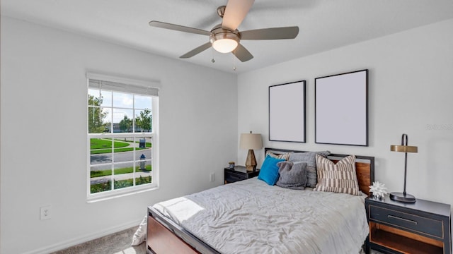 bedroom with multiple windows, baseboards, carpet floors, and ceiling fan