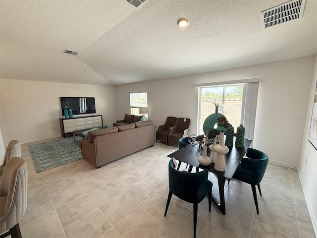 945 Laurel View Way, Groveland, FL 34736 - dining space featuring a textured ceiling, lofted ceiling, and light tile patterned floors