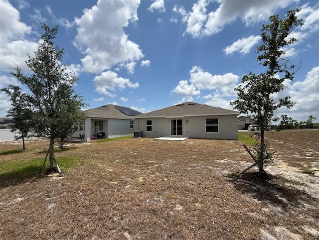 945 Laurel View Way, Groveland, FL 34736 - rear view of house featuring a patio area, stucco siding, and roof mounted solar panels