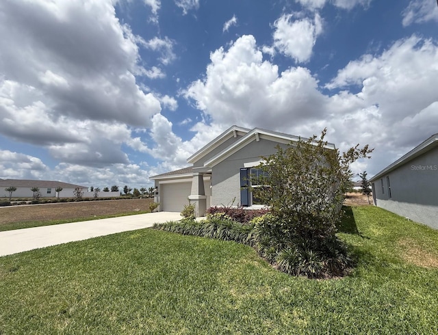 945 Laurel View Way, Groveland, FL 34736 - view of side of property featuring stucco siding, concrete driveway, an attached garage, and a yard