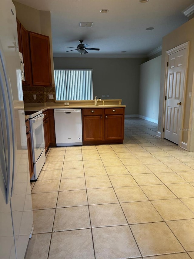 kitchen with white appliances, light tile patterned floors, a ceiling fan, visible vents, and a peninsula