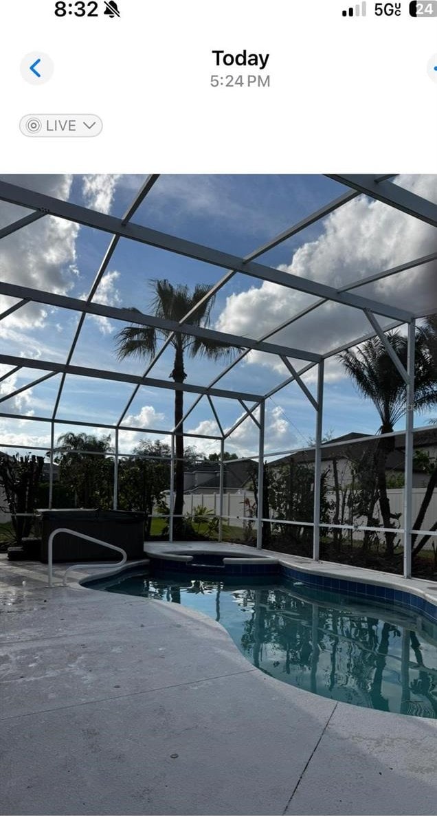 outdoor pool featuring a lanai and a patio area