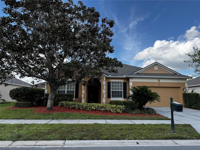 single story home featuring stucco siding, a front lawn, a garage, and driveway