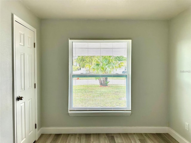 interior details featuring wood finished floors and baseboards