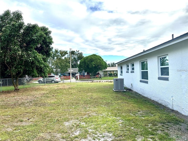 view of yard featuring cooling unit and fence