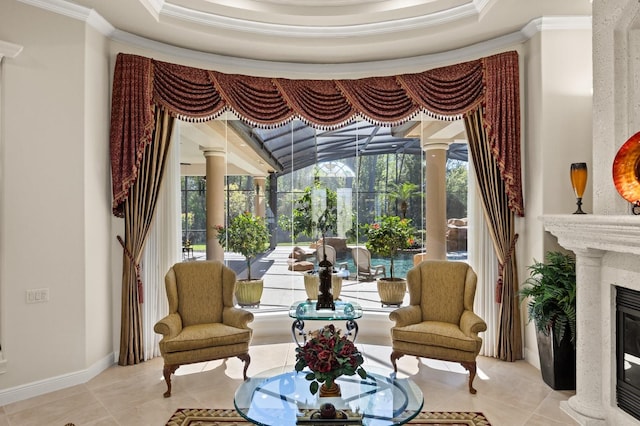 sitting room featuring baseboards, ornate columns, a fireplace, ornamental molding, and tile patterned floors