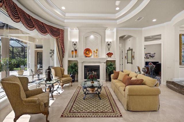 interior space featuring visible vents, a tray ceiling, a glass covered fireplace, arched walkways, and light tile patterned floors