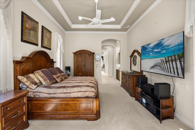 bedroom featuring visible vents, crown molding, light colored carpet, arched walkways, and a raised ceiling