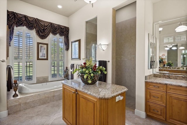 full bathroom with tile patterned floors, a garden tub, and vanity