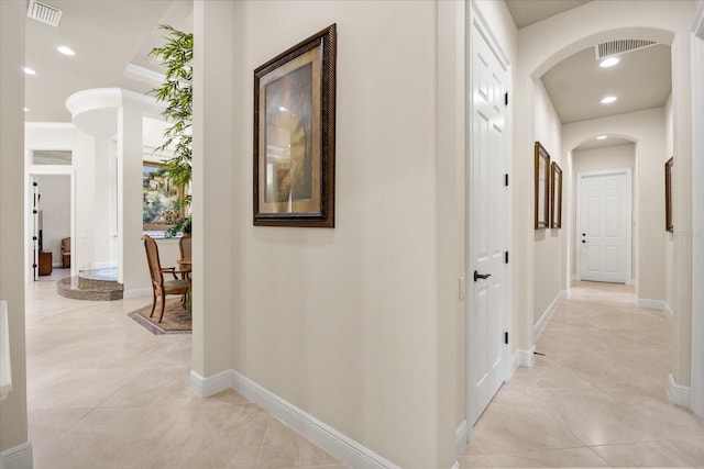 hall featuring recessed lighting, arched walkways, and visible vents