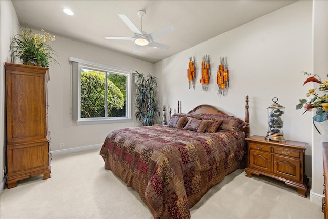 bedroom featuring recessed lighting, light colored carpet, baseboards, and ceiling fan