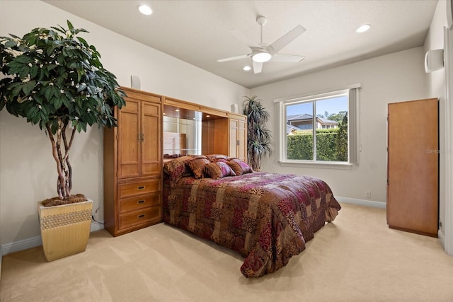 bedroom with recessed lighting, light colored carpet, and baseboards