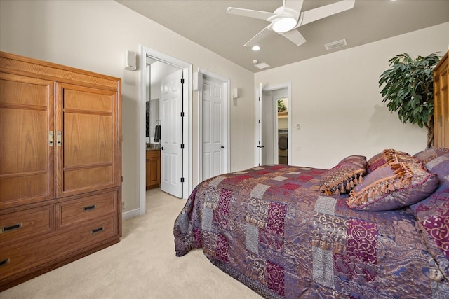 bedroom with visible vents, light carpet, washer / clothes dryer, ensuite bath, and ceiling fan