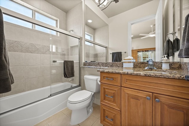 full bathroom featuring vanity, a ceiling fan, enclosed tub / shower combo, tile patterned flooring, and toilet