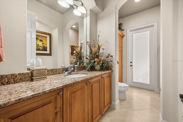 bathroom with vanity, tile patterned floors, and toilet